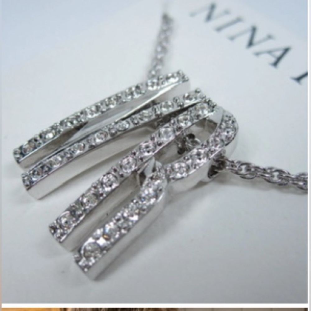 Nina Ricci Rhodium Plated
Pendant with Swarovski Crystals
- 16-18" length